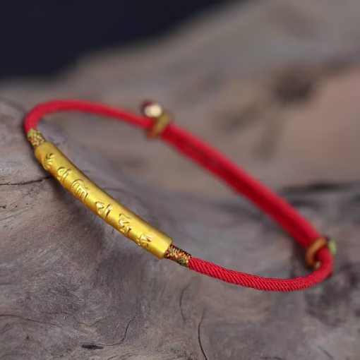 Tibetan red string bracelet with gold Om Mani Padme Hum mantra bar on driftwood adjustable sliding knot visible